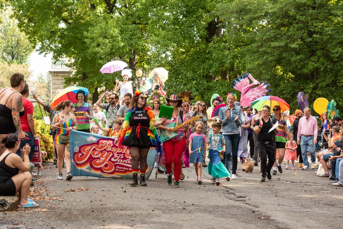 Colorful parade with diverse participants and banners.